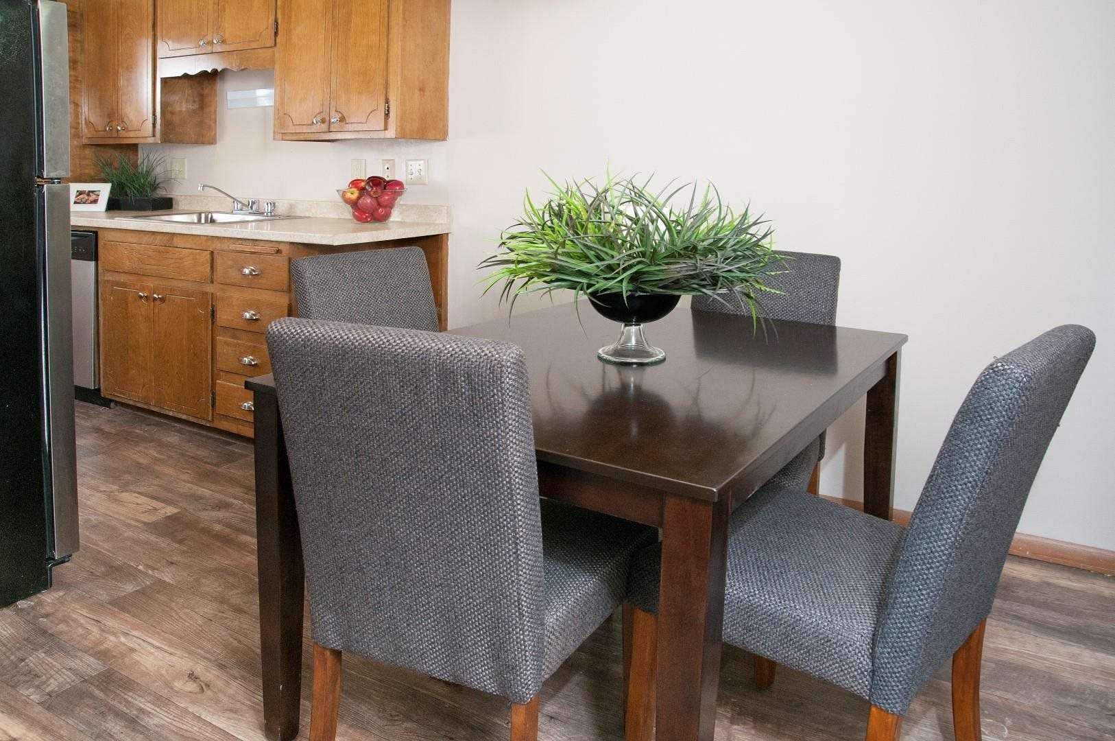 Dining Room Connected to Kitchen With Hard Wood Floors in St. Louis Park Apartment