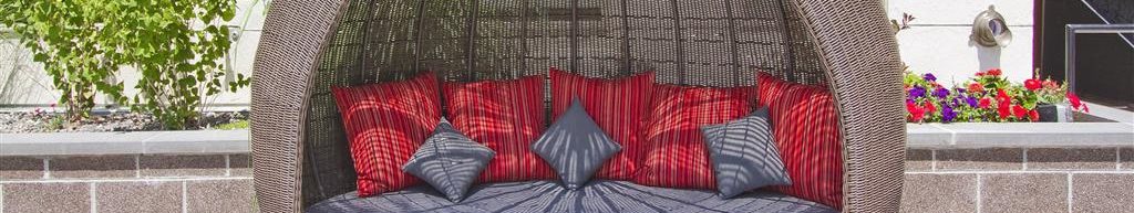Rooftop Lounge chair with red and gray pillows