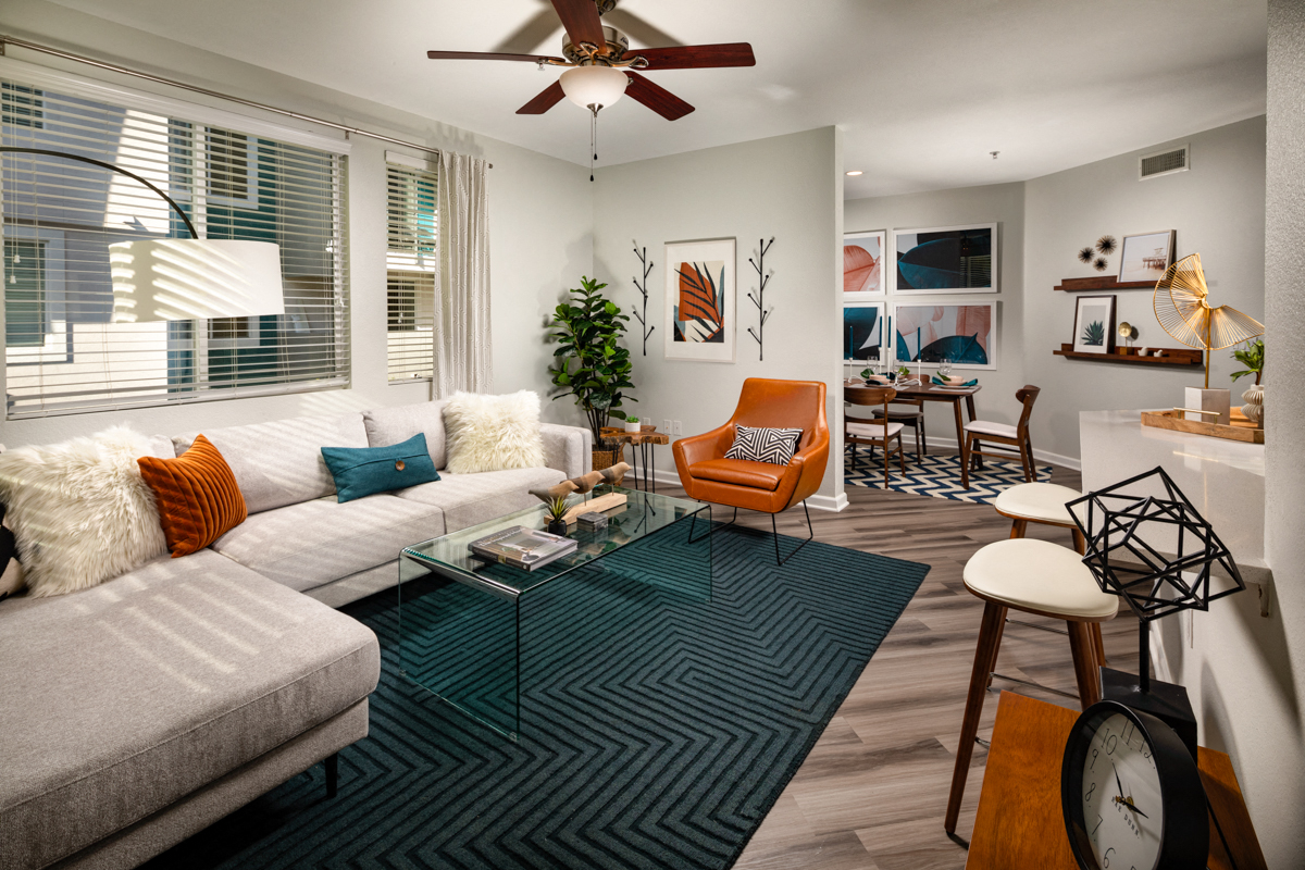 La Mesa, CA Apartments for Rent - The District - Living Room with a Ceiling Fan, Wood-Style Floors, and Open Floor Plan