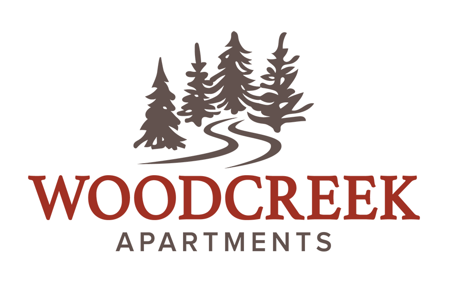 Logo for Woodcreek Apartments in Poulsbo, WA.