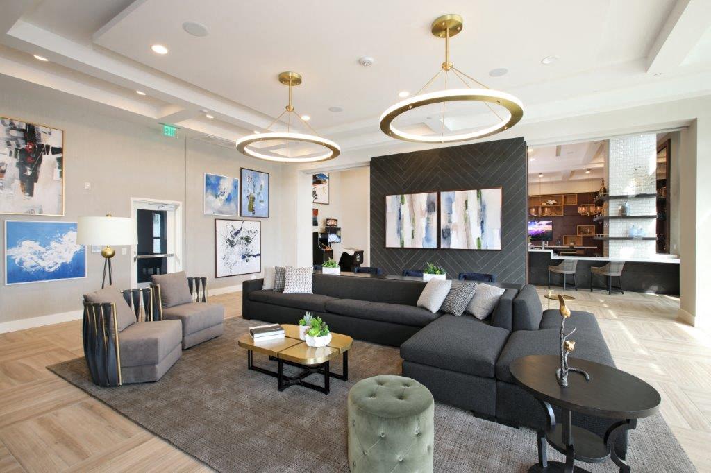 Spacious living room with couches, chairs, and a table at the Yacht Club