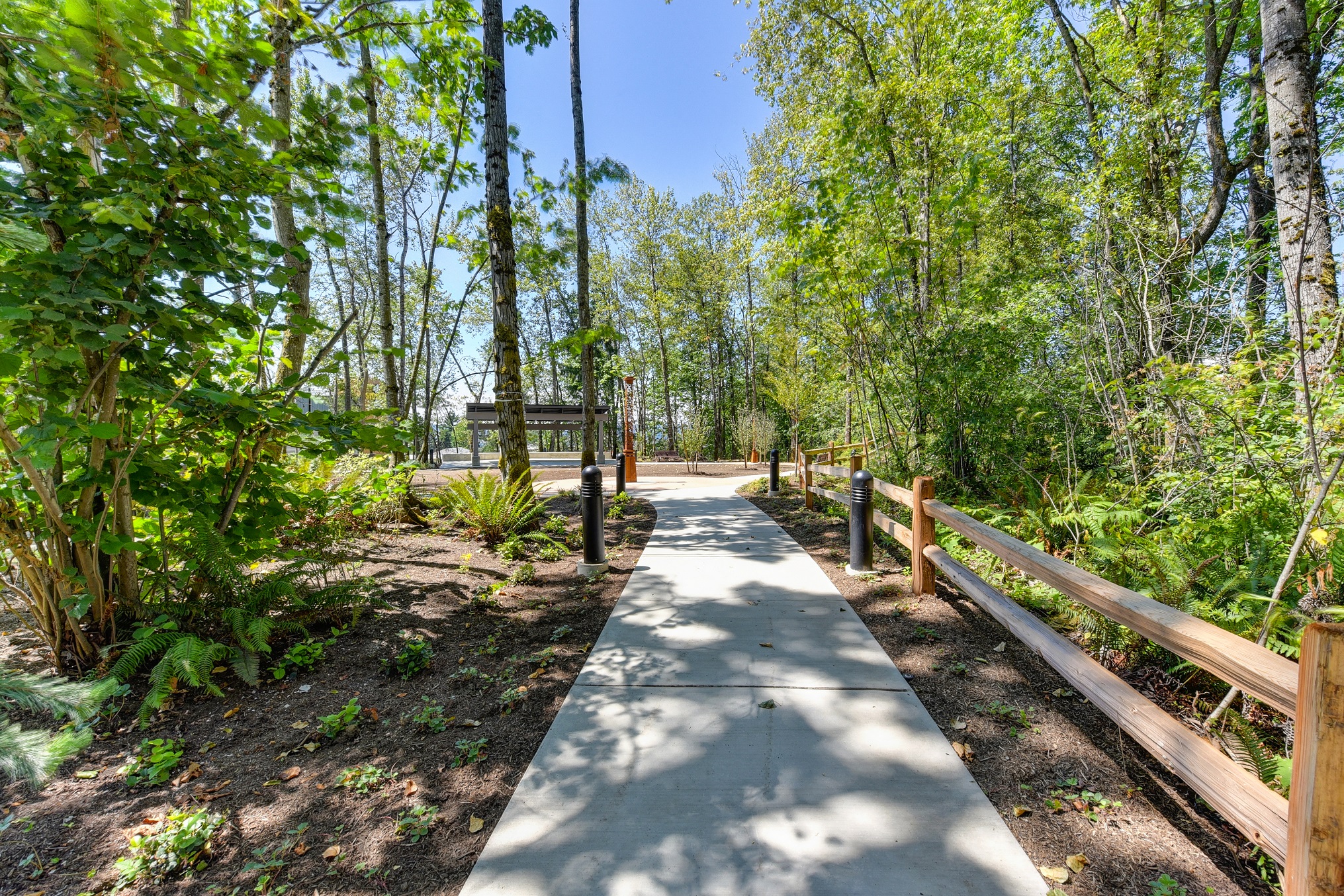 Walking Trail with Cement Path,  Wood Chip Ground, Trees, and Wooden Fence